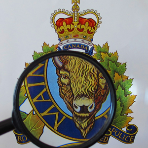 Photograph of magnifying glass over RCMP crest
