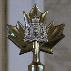 Photograph of Maple Leave flag head with crest of the RCMP 